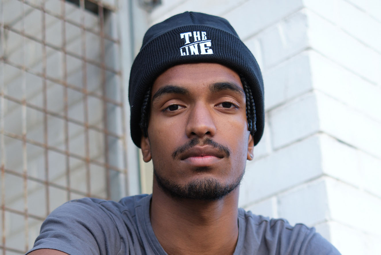 A young man wearing a The Line beanie. A young man wearing a The Line beanie.