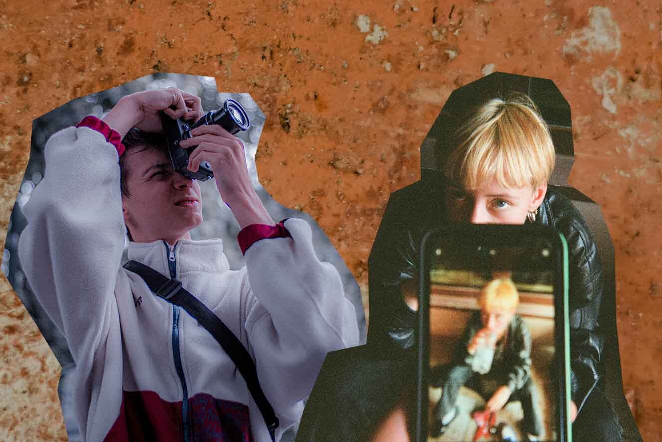 Two people are engaging with photography against a textured backdrop. One is taking a photo with a DSLR camera, while the other is being photographed and is visible through a smartphone screen held in the foreground.