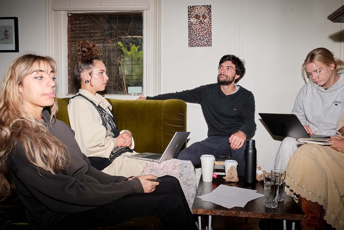 A group of four people sitting on couches. A group of four people sitting on couches.