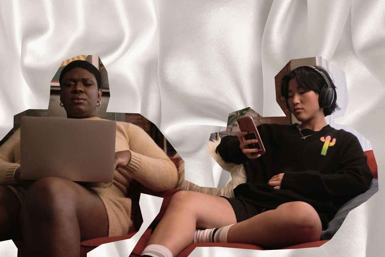 Two young people sitting side by side against a white silky backdrop. The person on the left is using a laptop, and the person on the right is holding a mobile phone