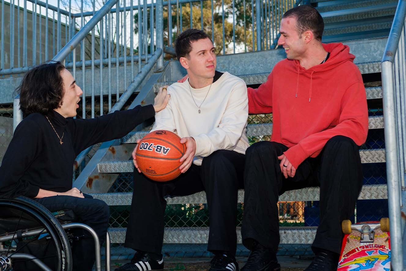 Three young men interact with each other. Three young men interact with each other.