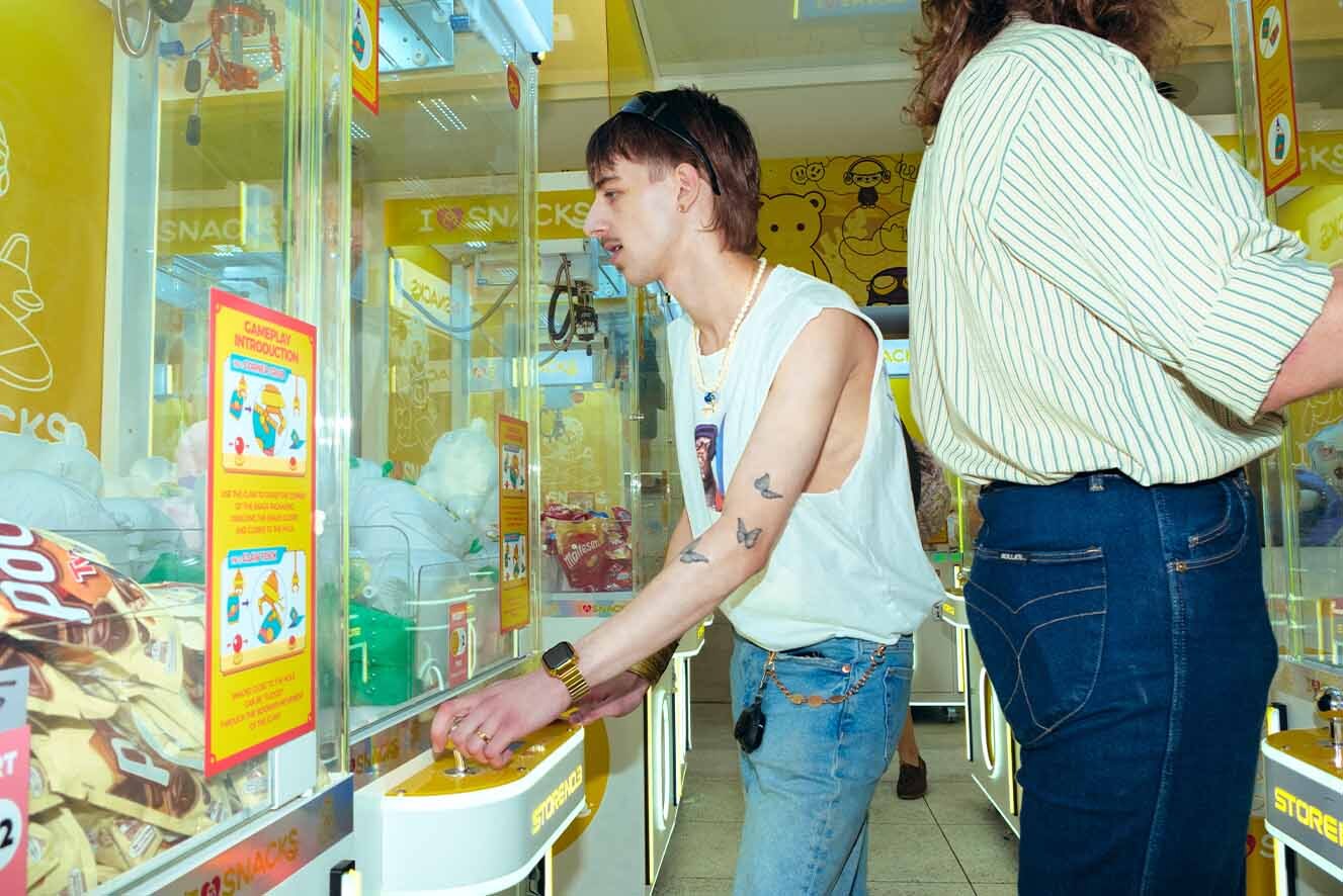 Two young men in an arcade. Two young men in an arcade.