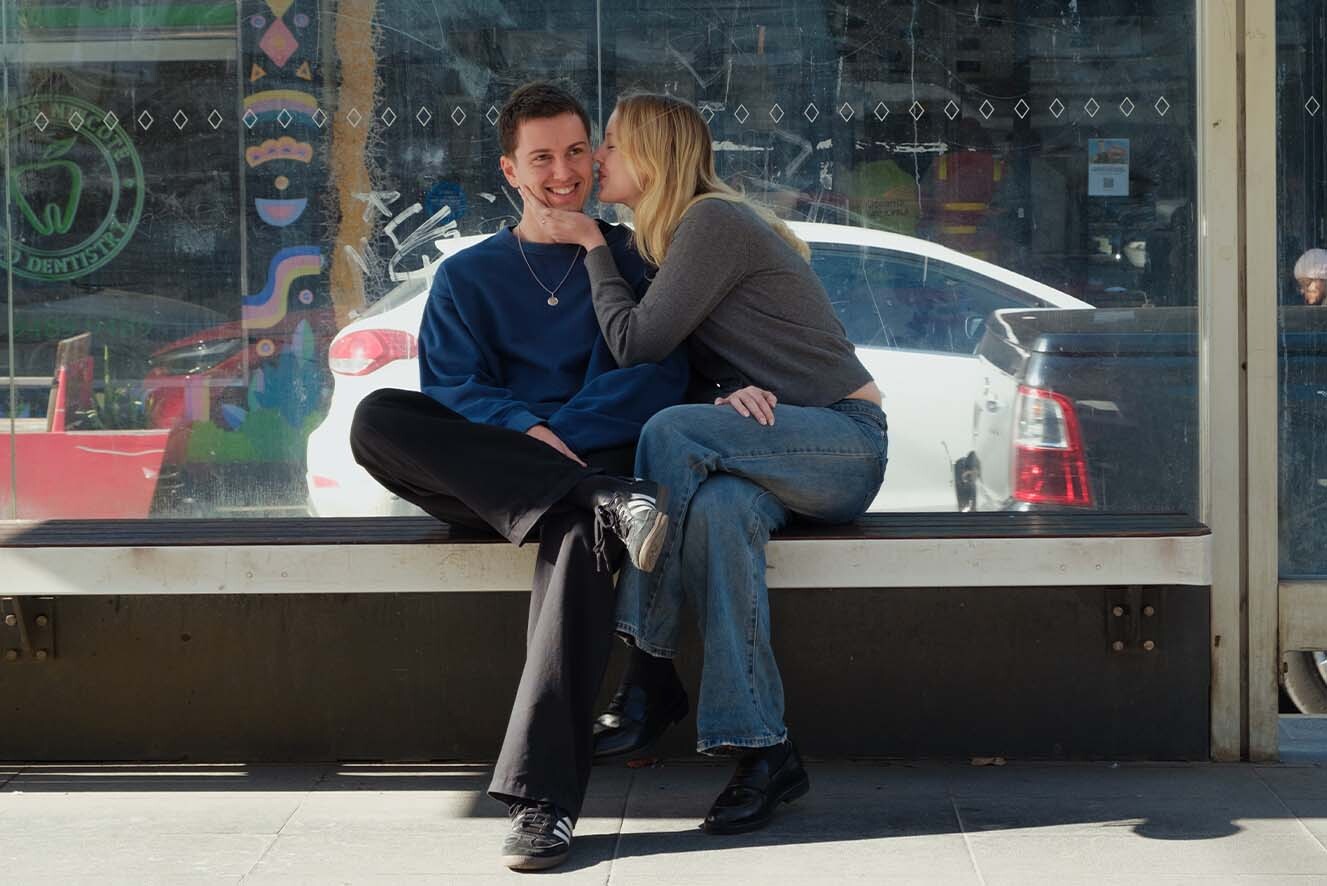 Young couple at tram stop smiling. Young couple at tram stop smiling.