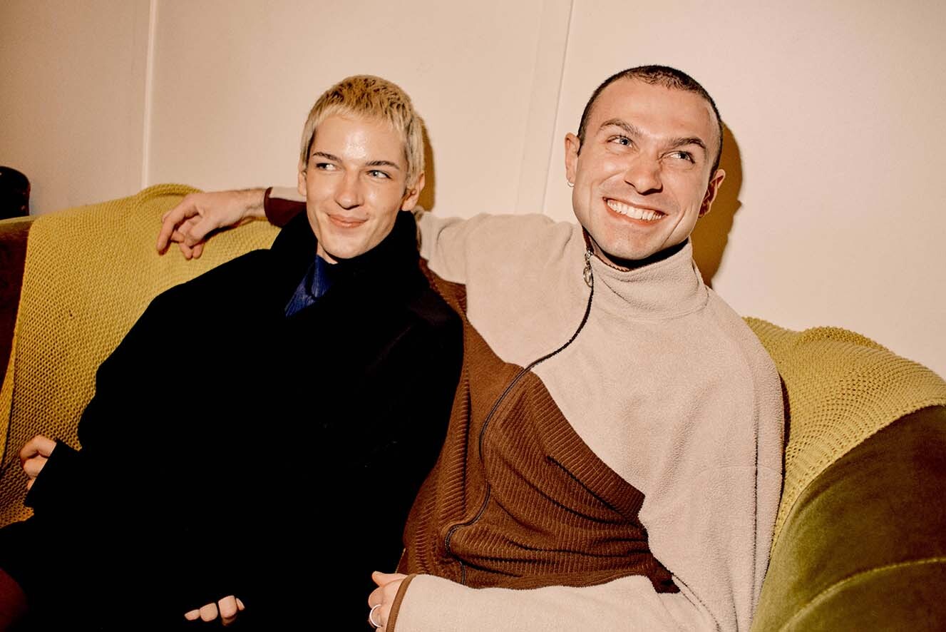 Young couple next to each other on a couch. Young couple next to each other on a couch.