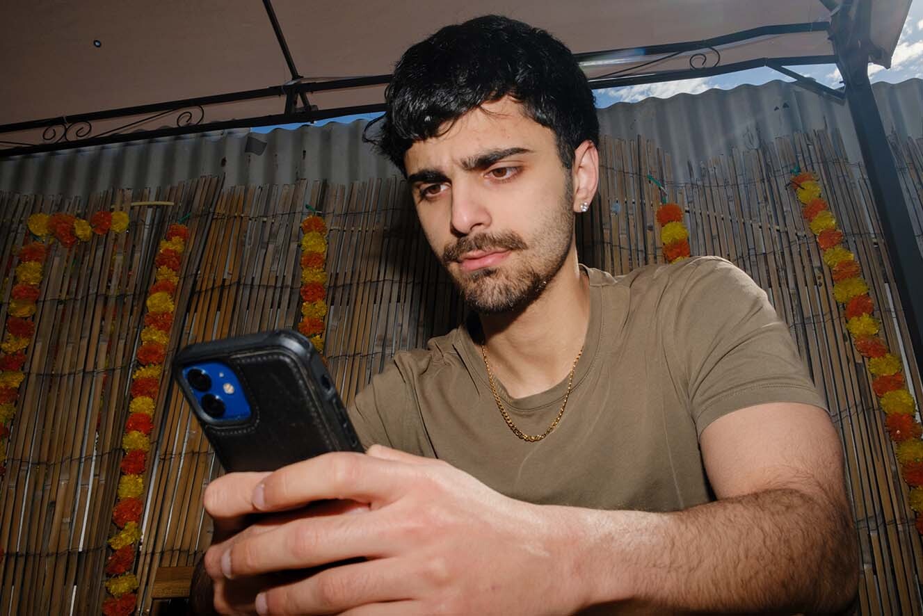 A young man on his phone. A young man on his phone.