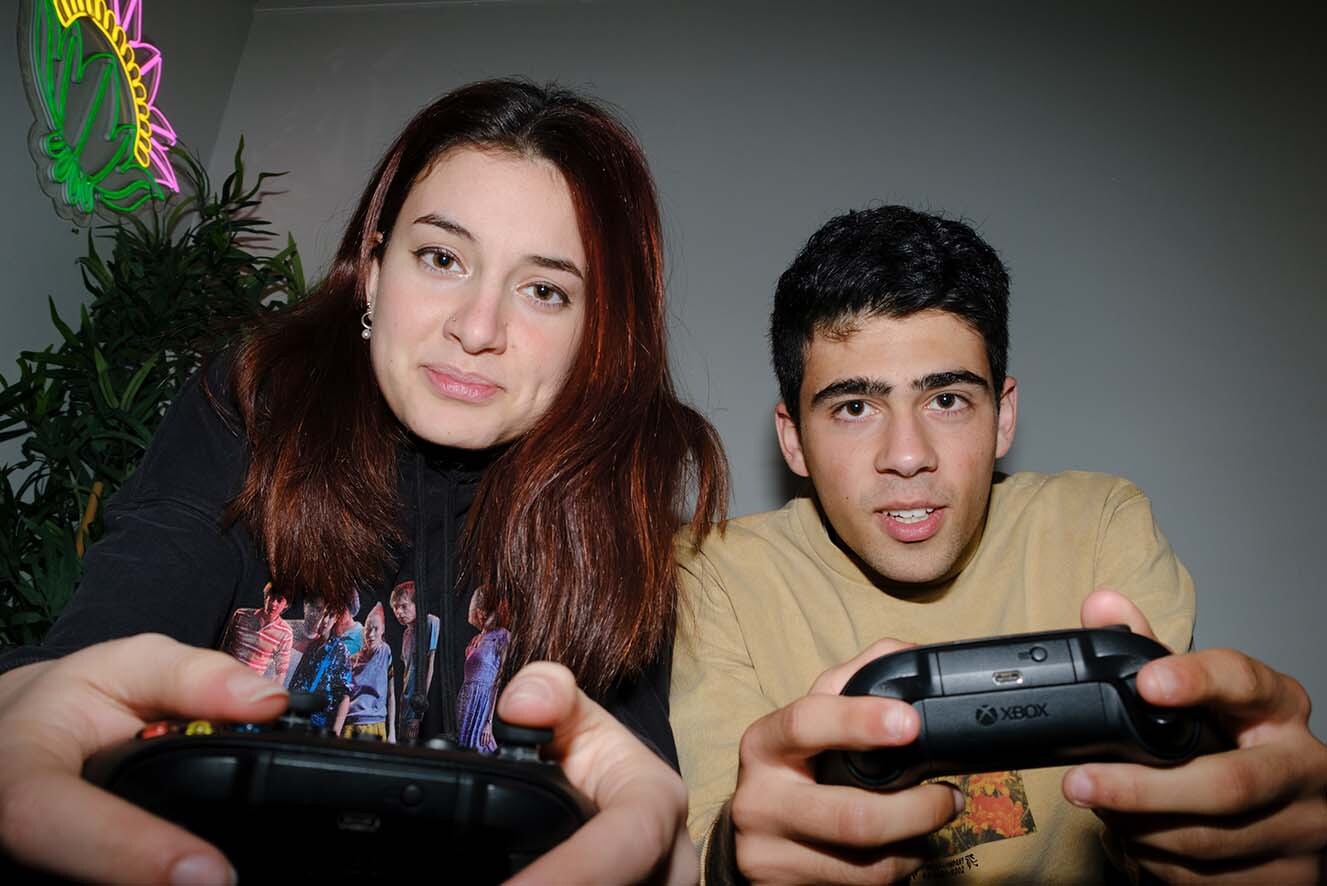 A young woman and young man play xbox. A young woman and young man play xbox.