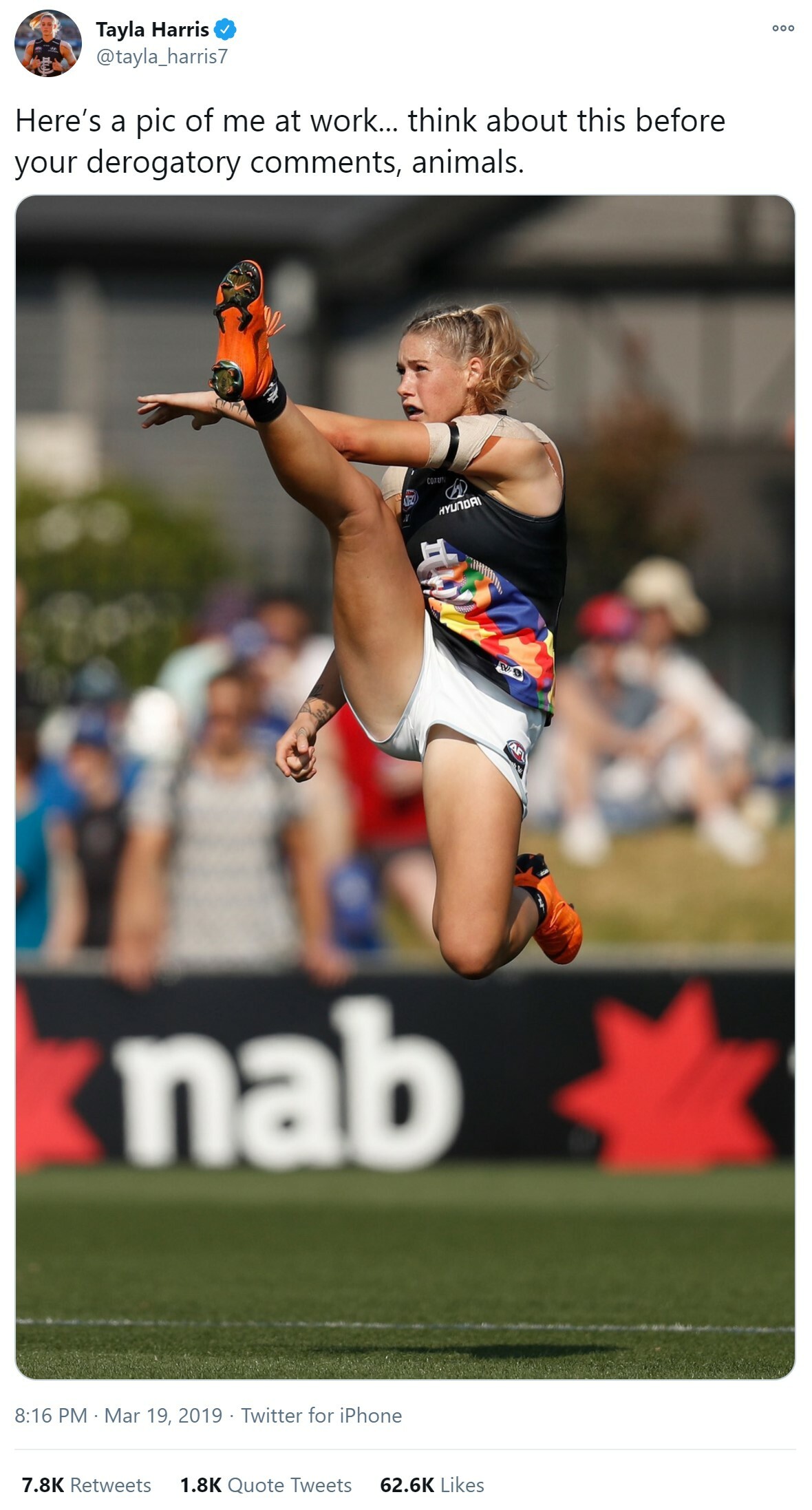 Tweet from Tayla Harris with a photo of her playing AFL with her right leg high up in the air. The caption says Here's a pic of me at work...think about this before your derogatory comments, animals.