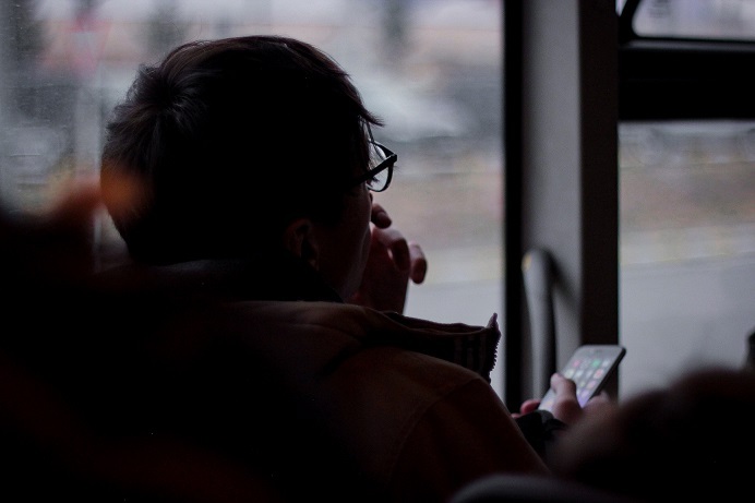 Man sitting on chair looking at phone