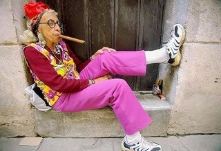 Picture of fashionable old lady smoking a cigar.