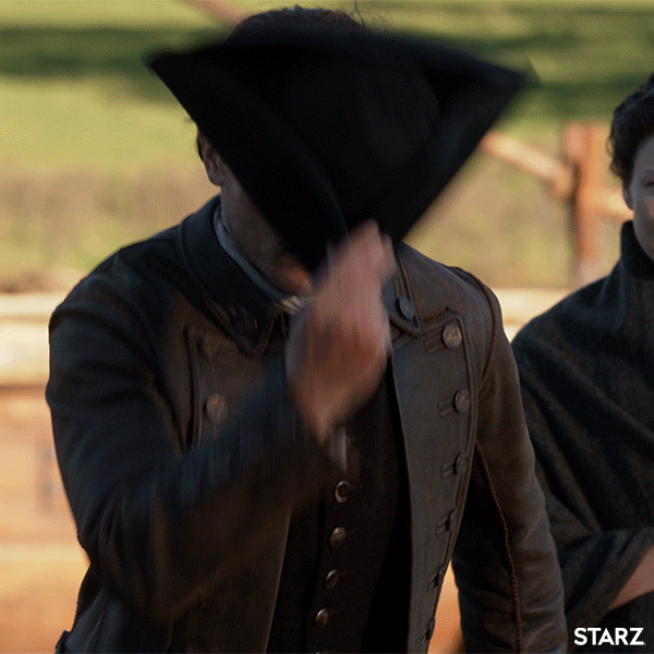 Male character (Jamie Fraser) from the TV show Outlander taking off his hat and bowing.